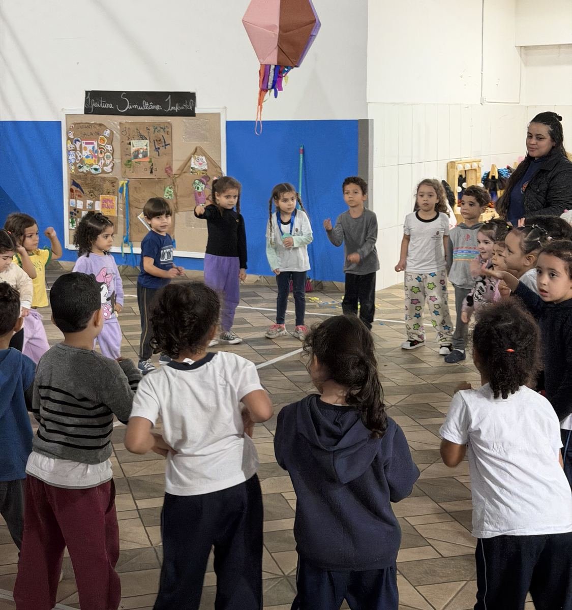 Children standing in a circle in the daycare gym