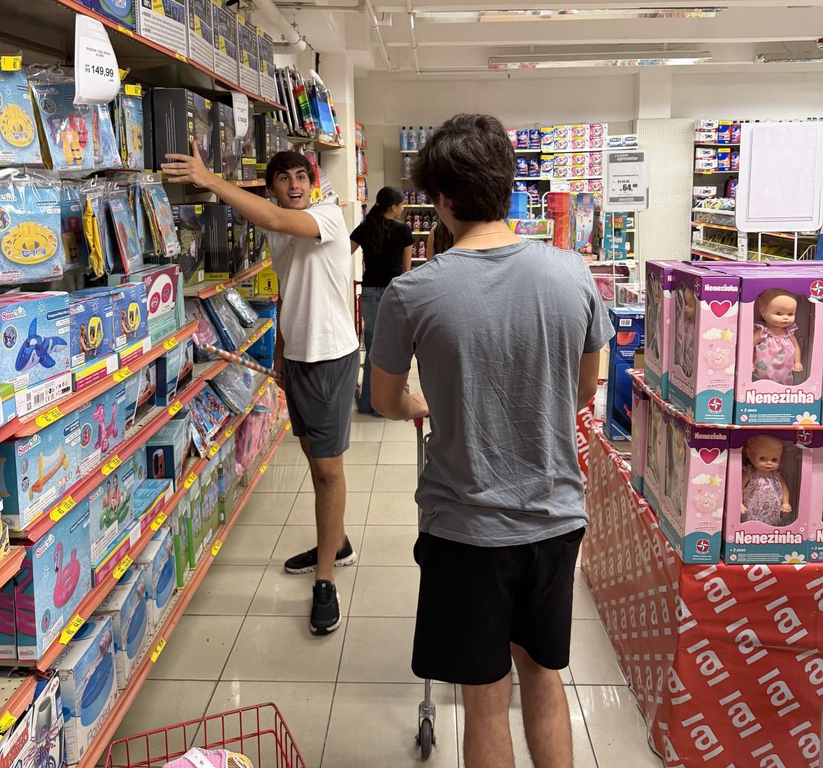 A member reaching for toys on a store shelf