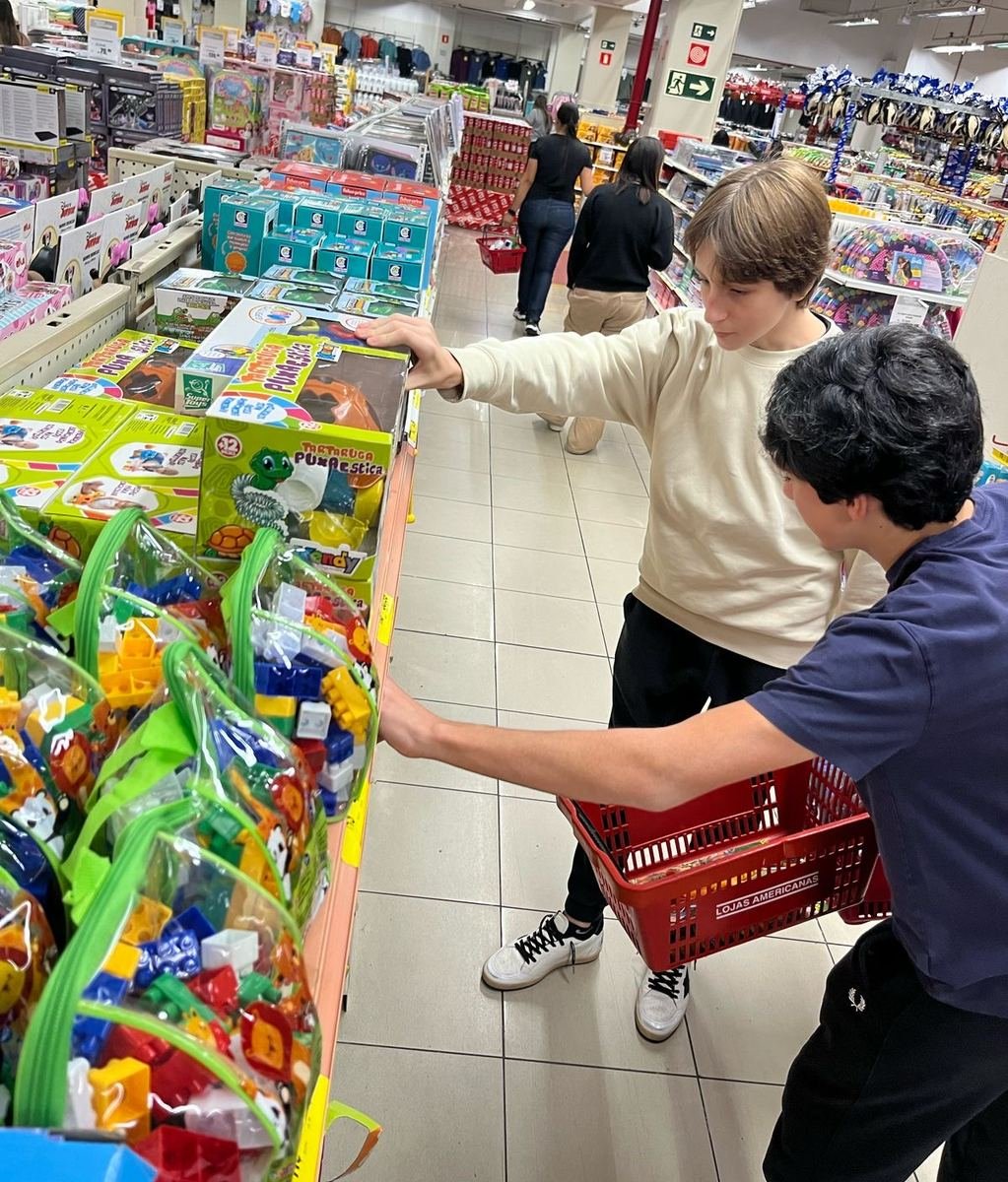 Two members choosing toys in a toy store aisle